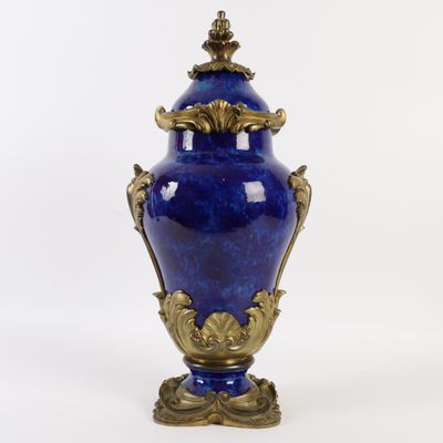 a large blue vase with a gold decoration on it