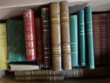 many books that are sitting on a shelf in a box