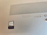 a close up of a silver laptop with a windows logo on it