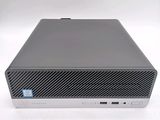 the back of a small computer with a keyboard on top of it
