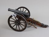a toy cannon sitting on top of a wooden cart