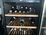 many bottles of wine on the shelves in the wine cooler