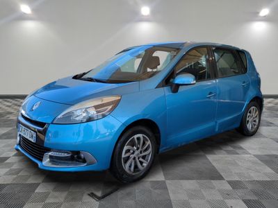 a blue car is parked in a room with a checkered floor