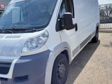 a picture of a white van parked in front of a building