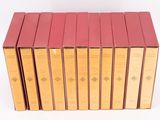 six books are stacked on top of each other on a white surface