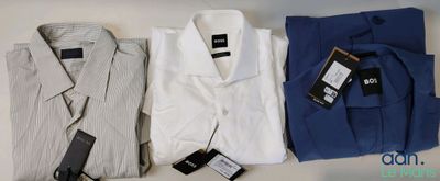 Trois chemises pour homme sont alignées sur une table