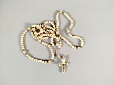un chapelet et une croix posés sur une table