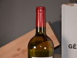 a bottle of wine that is sitting next to a box