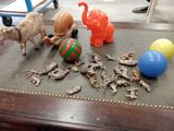 a table with a bunch of toy animals on it