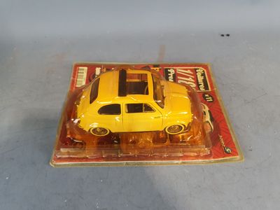 a yellow toy car sitting on top of a magazine