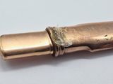 an old brass pipe that is on a white surface