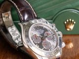 a watch sitting on a table next to a green purse