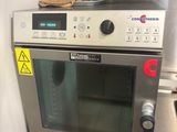 a silver oven with a glove on top of it