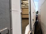 a white trailer that is parked inside of a building