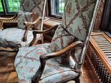 two chairs that are sitting in the sun room