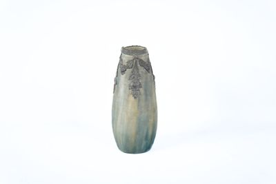 a vase that is sitting in the snow on a white surface