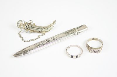 un stylo, une bague et un collier posés sur une table