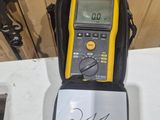 a yellow and black electronic device sitting on a white table