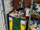 a refrigerator in a garage with a bunch of items