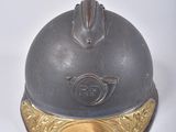 a silver and gold helmet on a white surface