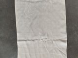 a white towel on a table with a black and white picture