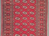 a red and black rug with a pattern on it