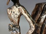 a bronze statue of a man and a woman holding hands