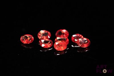 a group of red diamonds sitting on top of a black surface