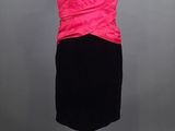 a black and pink dress on a mannequin stand