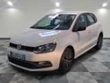 the white volkswagen polo is parked on a checkered tile floor