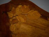 a wooden headboard with a leaf design on it