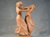 statue of a woman holding a man ' s head on a base