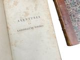 two old books sitting next to each other on a table