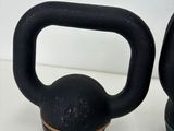 two kettle weights sitting next to each other on a table