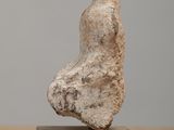 statue of a woman sitting on a block on a table