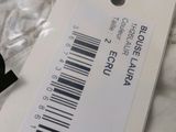 a white tag with a barcode on it on a bed