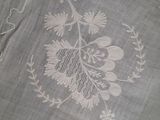 a close up of a table cloth with a flower design on it