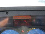 a close up of a car dashboard with a speedometer and gauges