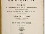 an old book with black writing on it sitting on a table