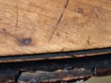 a close up of a wooden table with peeling paint on it