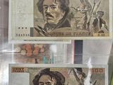 two different bills in a display case on the table