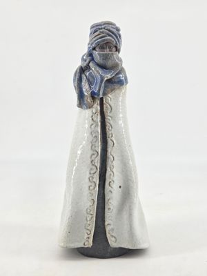 a figurine of a woman in a white robe and scarf