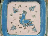 a blue and white plate with a bird on it