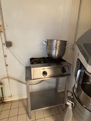 an image of a kitchen with a stove and a washing machine