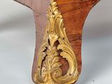 a wooden table with a gold decoration on it