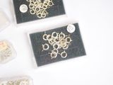 many different types of jewelry in a box on the table