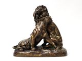 bronze statue of a lion and a dog on a white background