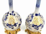 pair of blue and white vases with gold accents on a white background