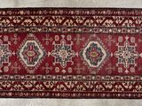 an old rug with a red and white design on it
