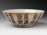bowl with asian writing on it on a white surface